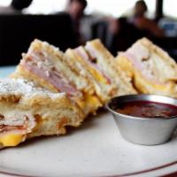 Monte Cristo** · Ham, Turkey, Swiss cheese, American cheese, battered and deep fried. Served with a side of r...