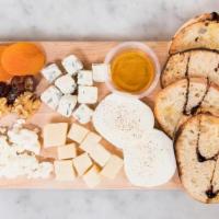 House Cheese Board · Fresh mozzarella, goat cheese, gorgonzola, and parmigiano reggiano. Served with dried aprico...