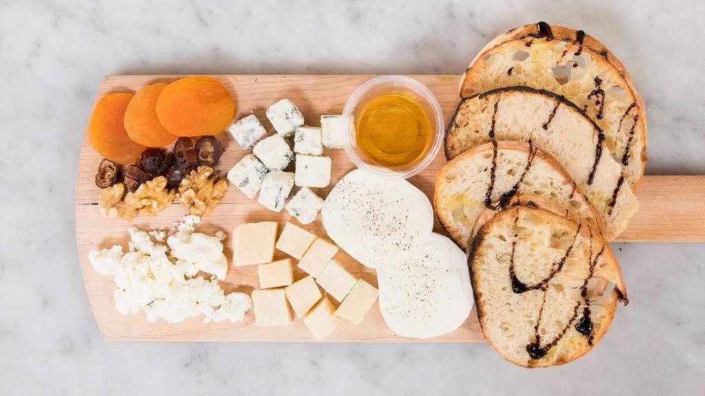 House Cheese Board · Fresh mozzarella, goat cheese, gorgonzola, and parmigiano reggiano. Served with dried apricots, dates, walnuts, and honey.  Prepared fresh with a balsamic reduction and artisan Neapolitan bread.