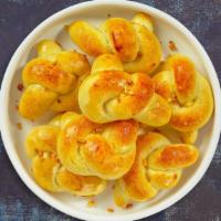 Tie The Garlic Knots · Our house made pizza dough, knotted up, baked, then smothered in real garlic butter and parm...