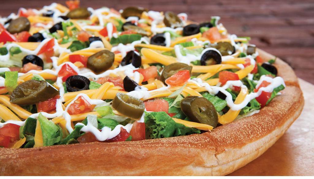 Nacho Pizza · Vegetarian. Taco sauce, refried beans, black olives, tomatoes, jalapeños, lettuce, sour cream, cheddar cheese and mozzarella cheese.