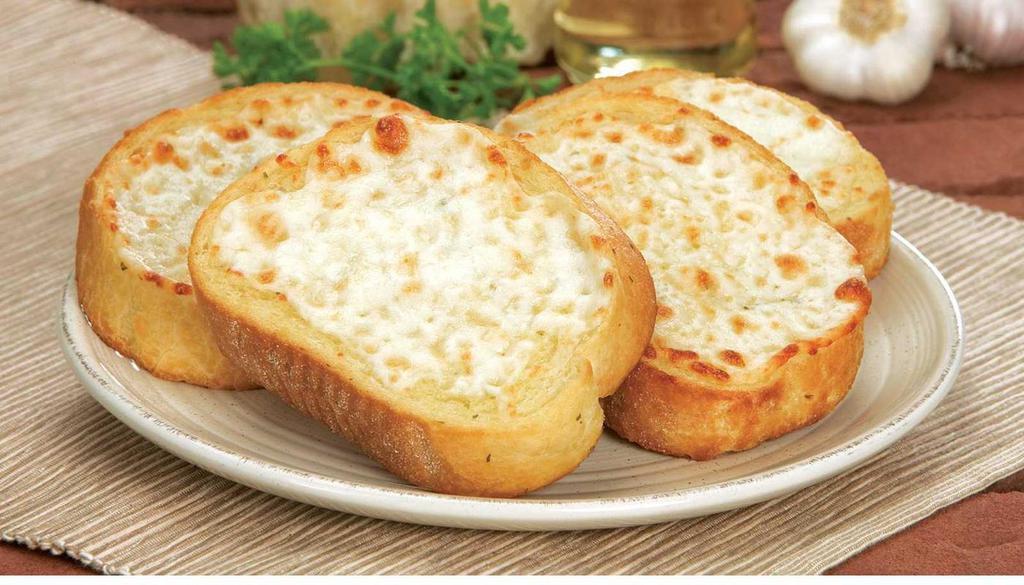 Cheese Bread · Oven-baked bread, brushed with a buttery garlic sauce, sprinkled with a blend of spices and finished with melted mozzarella cheese. 4 pieces.