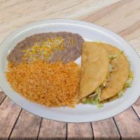Two Hard Tacos Special Locos · Two hard shell tacos topped with lettuce, and cheese, with a side of fried rice and pinto be...