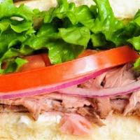 Prime Baggins · Slow roasted beef, cream cheese, mayo, horseradish, sweet onion, tomatoes and lettuce on an ...