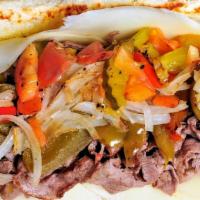 Beef Cheesesteak Sandwich · Sliced rib eye steak, Provolone cheese, tomatoes, grilled onions, dill pickles and mild swee...