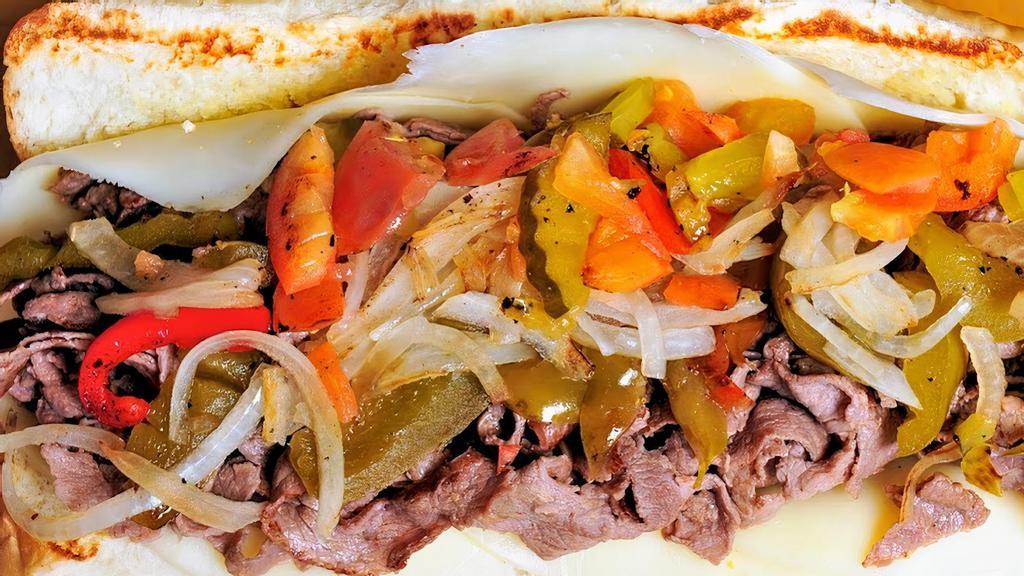 Beef Cheesesteak Sandwich · Sliced rib eye steak, Provolone cheese, tomatoes, grilled onions, dill pickles and mild sweet cherry peppers or hot jalapeños, on an 8