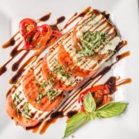 Caprese Salad · Fresh tomatoes, roasted red peppers, fresh mozzarella cheese with a balsamic glaze and basil