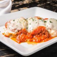 Eggplant Rollatini · Eggplant rolled up and stuffed with seasoned ricotta and mozzarella cheese in pomodoro
