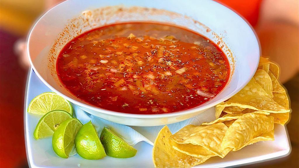 Menudo (32 Oz) · A traditional Mexican soup, cooked with tripe meat in broth with guajillo chili base, hominy, fresh limes, onions, oregano, and crushed arbol peppers. Served with your choice of bread, corn tortillas, or flour tortillas.