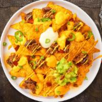 Loaded Nachos · Salted tortilla chips doused in melted nacho cheese and topped with ground beef, jalapenos, ...