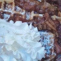 Bacon N Waffle · A hot Belgian waffle topped with two strips of bacon, powdered sugar and whipped cream, side...