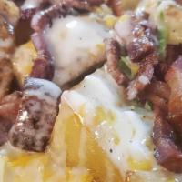 Baked N Loaded Taterz:  · Baked and roasted potato wedges with cheddar jack cheese, crispy bacon, creme fraiche and gr...