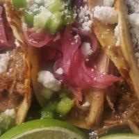 Munchies Street Tacos:    · Slow braised Carnitas on a cheese crusted corn tortilla topped with our salsa verde, pickled...