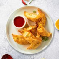 Red Chili Dumplings · Six deep-fried dumplings topped with sweet chili sauce, and cilantro.