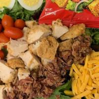 Crispy Cobb Salad · Mixed greens, crispy chicken, bacon, eggs, cheddar, tomatoes, and croutons