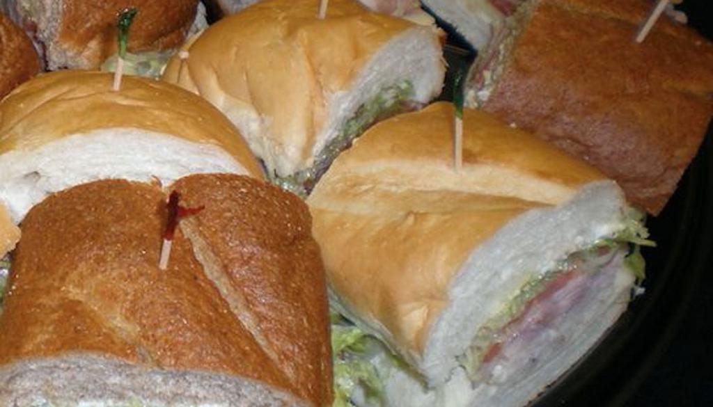 Medium Sub Tray · Turkey and Italian subs with mayo, mustard, lettuce, tomatoes, and light house dressing. 10 servings, Feeds 5