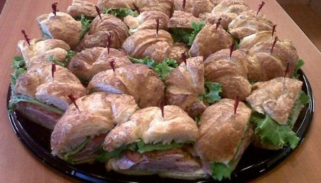 Croissant Tray · *24 hour advance notice. Buttery croissants with 3 types of sandwiches: Turkey & Provolone, Ham & Provolone, and Chicken Salad, all prepared dry with lettuce & tomato and mayo/mustard on the side. Feeds 12