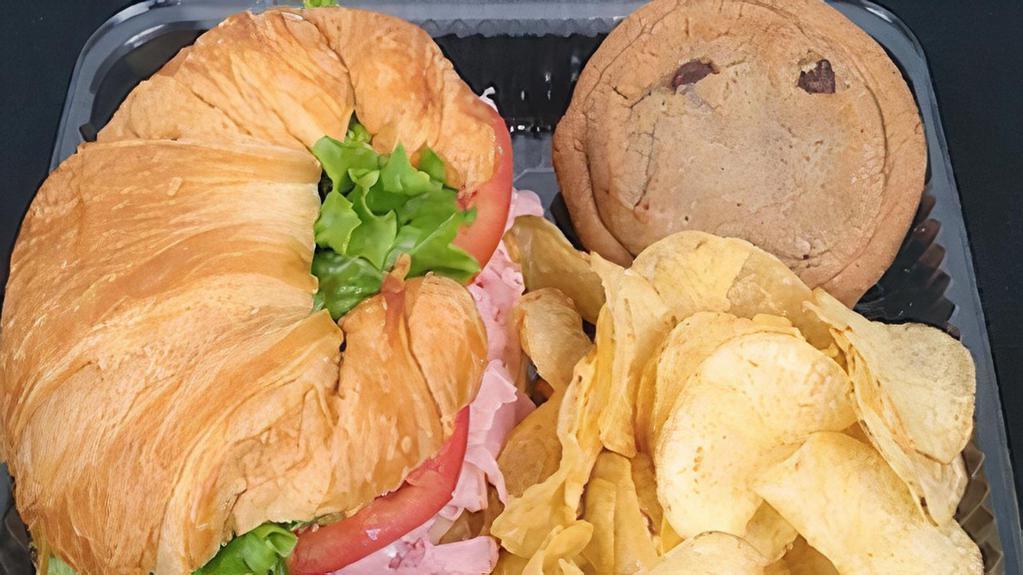 Croissant Box Lunch · Individually boxed Croissant, Kettle Chips, and Cookie. Sandwich made with lettuce, tomato, and mayo/mustard packets on the side. Consider adding a bottle drink. Minimum order of 8 boxes.