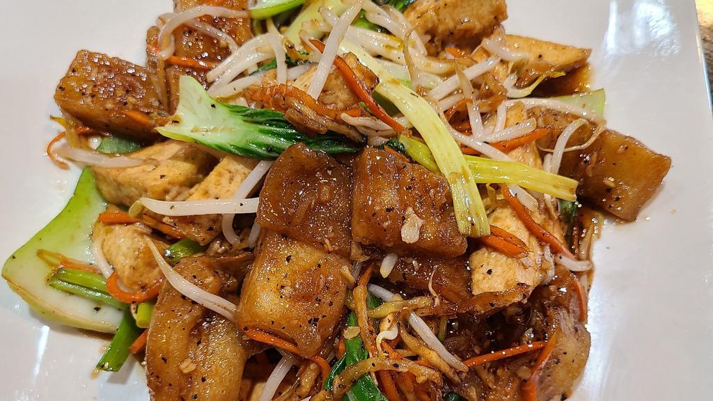 Vegan Stir Fried Rice Noodle · Pan fried rice noodle, tofu, bok choy, carrots, yellow & green onion, bean sprouts stir fried in special sauce.