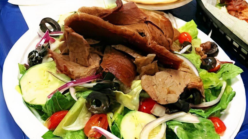 Salad Bowls Gyro · Gyro meat over our Greek salad with tortilla chip croutons & our special Dressing serve with our special sauce and feta cheese.