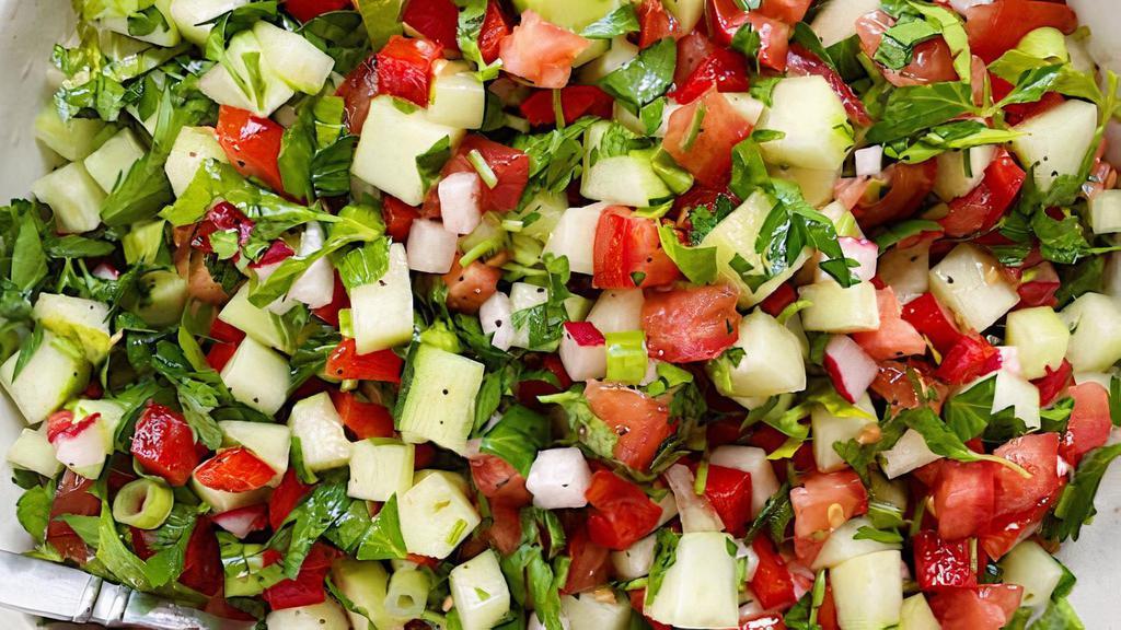 Arabic Salad · Fresh tomatoes and cucumbers with parsley topped with lemon and olive oil.