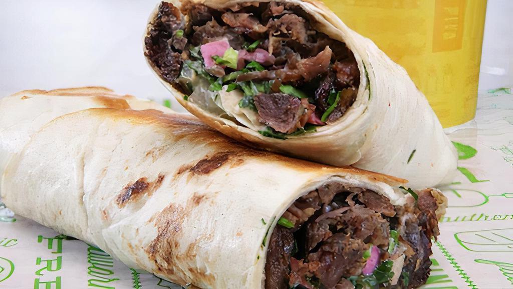 Lamb Shawarma Wrap · Lamb Wrapped with tortilla bread with pickle onion tomato and garlic sauce - served with fries.