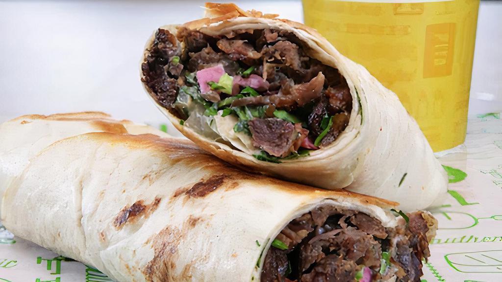 Beef Shawarma Wrap · Beef Wrapped with tortilla bread with pickle onion tomato and garlic sauce - served with fries.