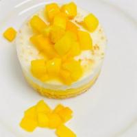 Dessert - Mango Mousse Cake · Almond sponge cake and mango mousse topped with whip cream and toasted coconut.