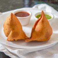 Veg Samosa · Crispy triangle puff pastry stuffed with potato, green peas and spices, deep fried, served w...