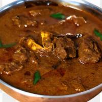 Hyderabad Goat Masala · Spicy goat chunk cooked with red chilli musturd seeds curry