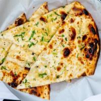 Garlic Naan · Fine flour bread topped with fresh garlic baked in tandoo.