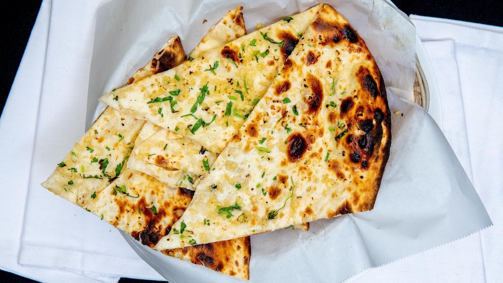 Garlic Naan · Fine flour bread topped with fresh garlic baked in tandoo.