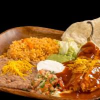 #17. Two Chile Rellenos · Two chile rellenos topped with enchilada sauce, sour cream, guacamole, lettuce, and pico de ...