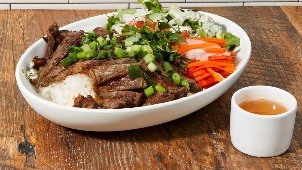 Grilled Short Ribs Bowl (Contains Gluten) · Grilled marinated boneless short ribs served with lettuce, pickled daikon carrot, satay scallions , cucumber, jalapeños, tomatoes, cilantro on hot  broken rice.