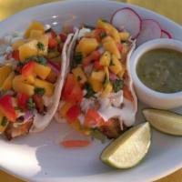 Single  Seafood Taco · Our homemade corn tortilla taco filled with 2oz of cod fish or shrimp,  and topped with a ch...
