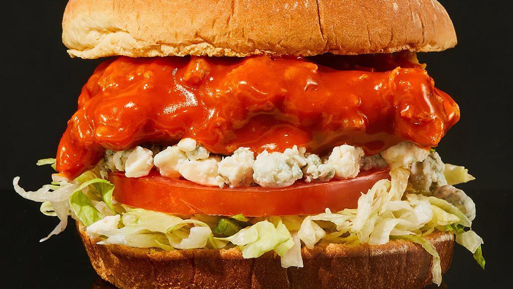 Buffalo Chicken Sandwich · Our signature fried chicken served on a toasted bun and topped with lettuce, tomato, blue cheese crumbles, ranch dressing and Buffalo sauce.