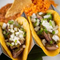 2 Lengua Tacos · Beef Tongue, Corn Tortillas, Onions, Cilantro, Chimichurri, Rice, Refried Beans