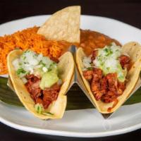 3 Vegan Carnitas Tacos · Jack Fruit Carnitas, Corn Tortillas, Tomatillo-Avocado Sauce, Onions, Cilantro, Rice, Refrie...