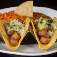 2 Vegan Chicken Tacos · Vegan Chicken with Al Pastor Salsa, Corn Tortillas, Tomatillo-Avocado Sauce, Onions, Cilantr...