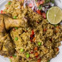 Arroz Con Pollo · Chicken rice dish cooked with fresh cilantro, vegetables, and bell peppers, served with a si...