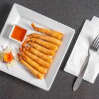 Prawn Rolls · Prawns wrapped in egg rolls wrappers, fried and served with sweet and sour sauce.