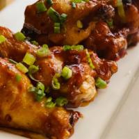 Honey Bbq Wings · Wings sautéed in garlic butter and chili flakes then tossed in our zesty honey bbq sauce top...