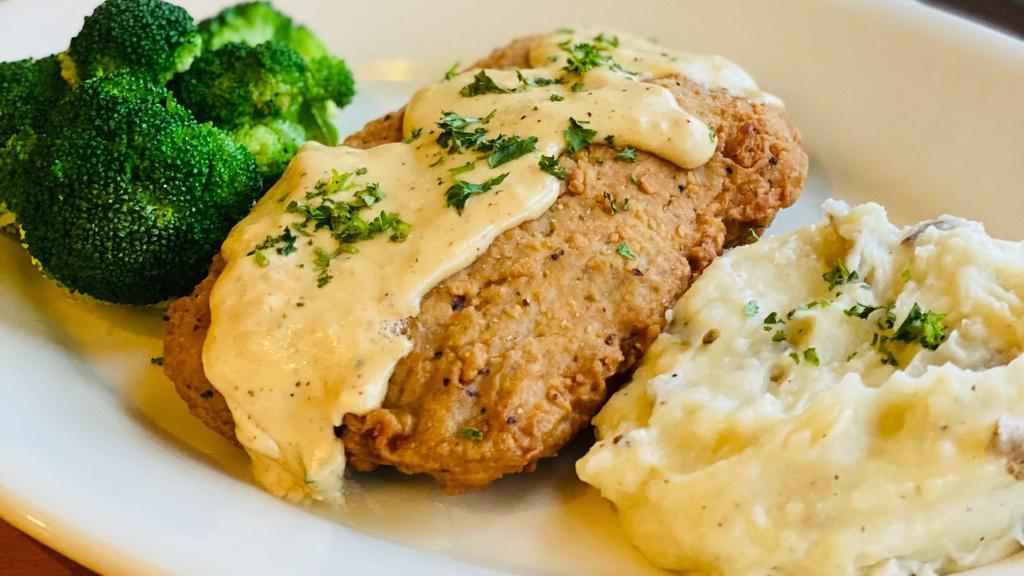 Country Fried Steak · Country fried steak drizzled in our Baja gravy served with seasonal vegetables and mashed potatoes.