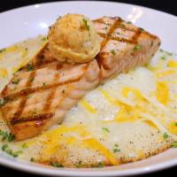Grits And Salmon · Our perfectly seasoned grits smothered in jack cheddar cheese and topped with your choice of...