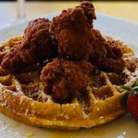 Chicken & Waffles · Belgian style waffle served with our zesty spicy wings topped with powdered sugar and drizzl...
