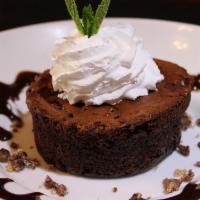 Lava Flow Brownie · Chocolate brownie with chocolate lava pouring from the center served warm with a scoop of va...