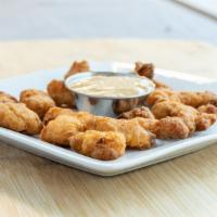 Gator Bites · Slices of alligator tenderloin battered in house and fried to a golden brown. Served with a ...