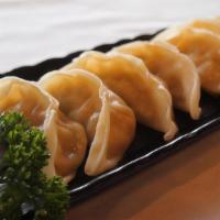 Steamed Gyoza · Steamed potstickers filled w/ pork & vegetables, & gyoza dipping sauce (8pc).