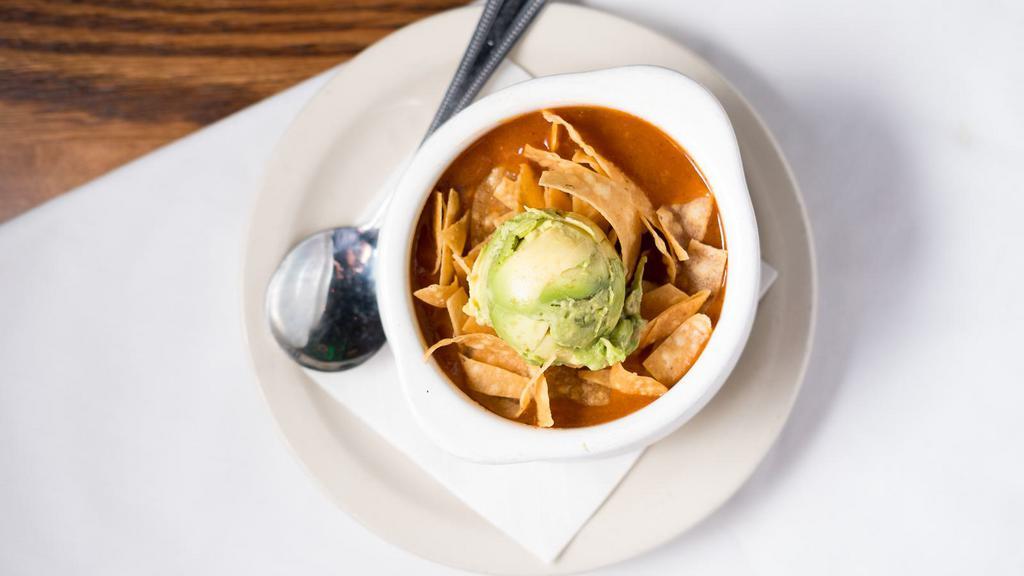 Chicken Tortilla Soup · Topped with tortilla strips and fresh avocado.