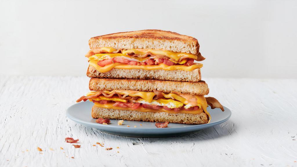The Regular · 2 fried eggs, bacon, American cheese, tomato & Society Sauce on choice of bread